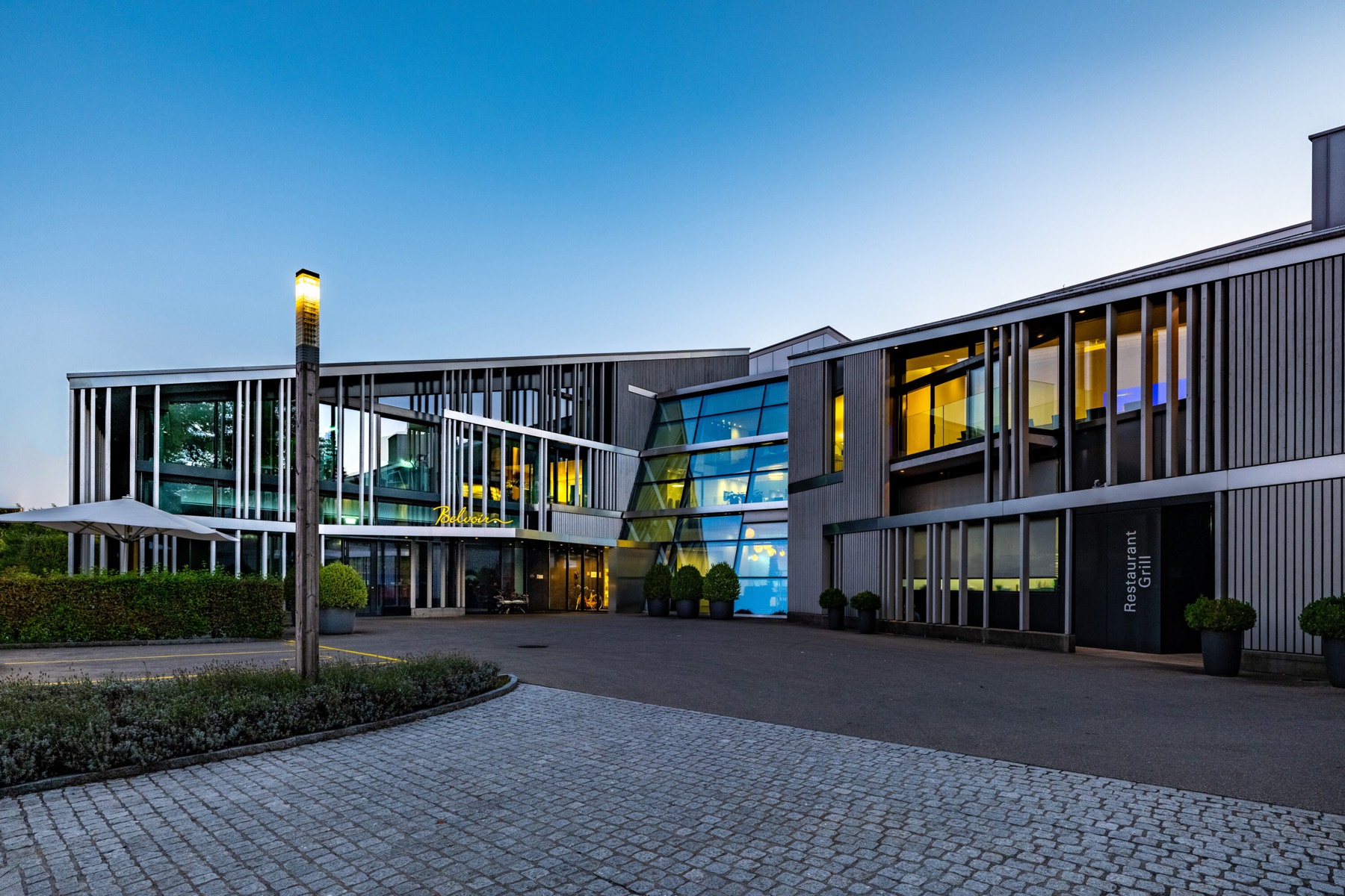 Hotel Belvoir exterior in Rüschlikon at dusk