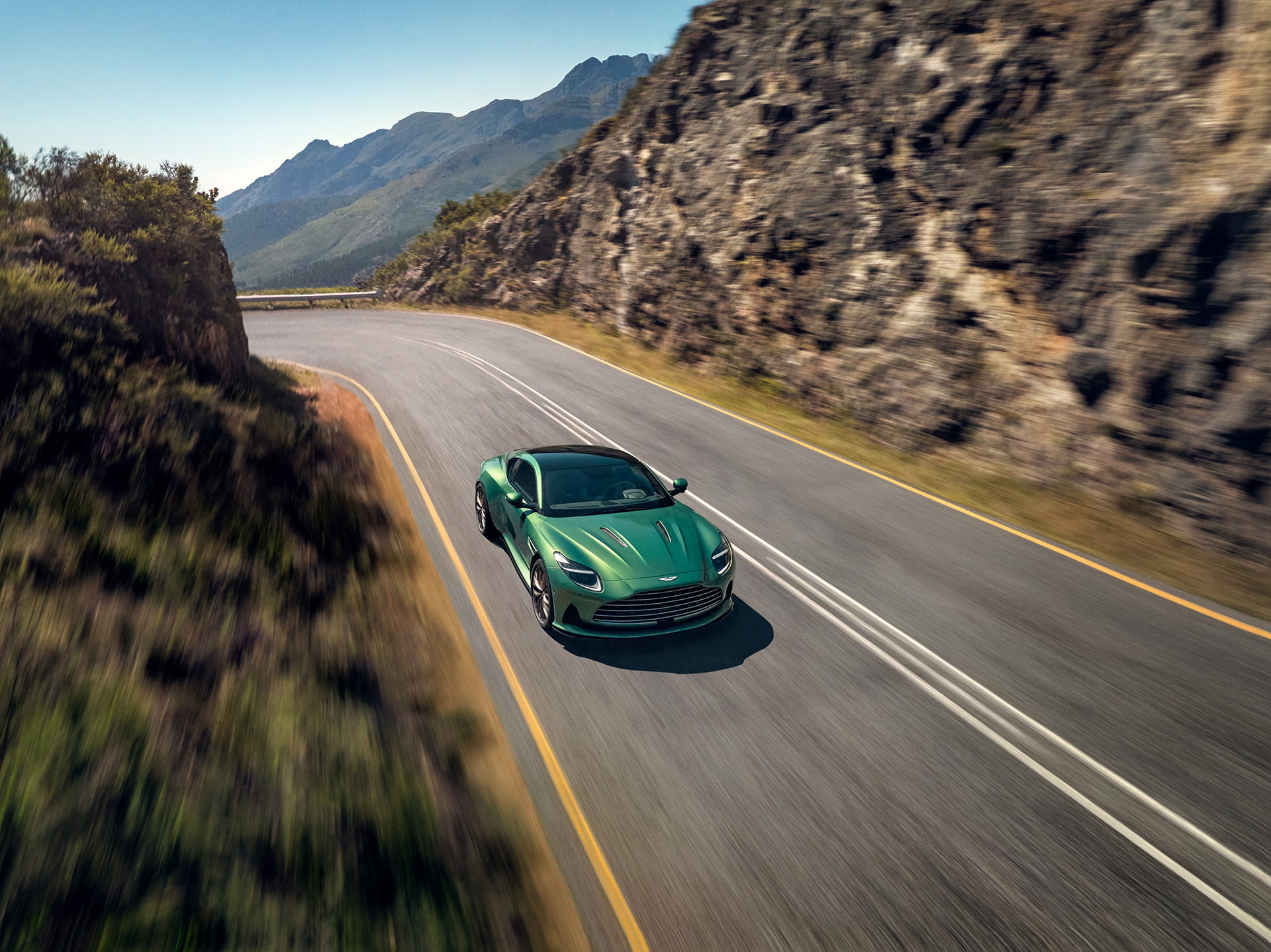 Aston Martin DB12 in British Racing Green on a mountain road