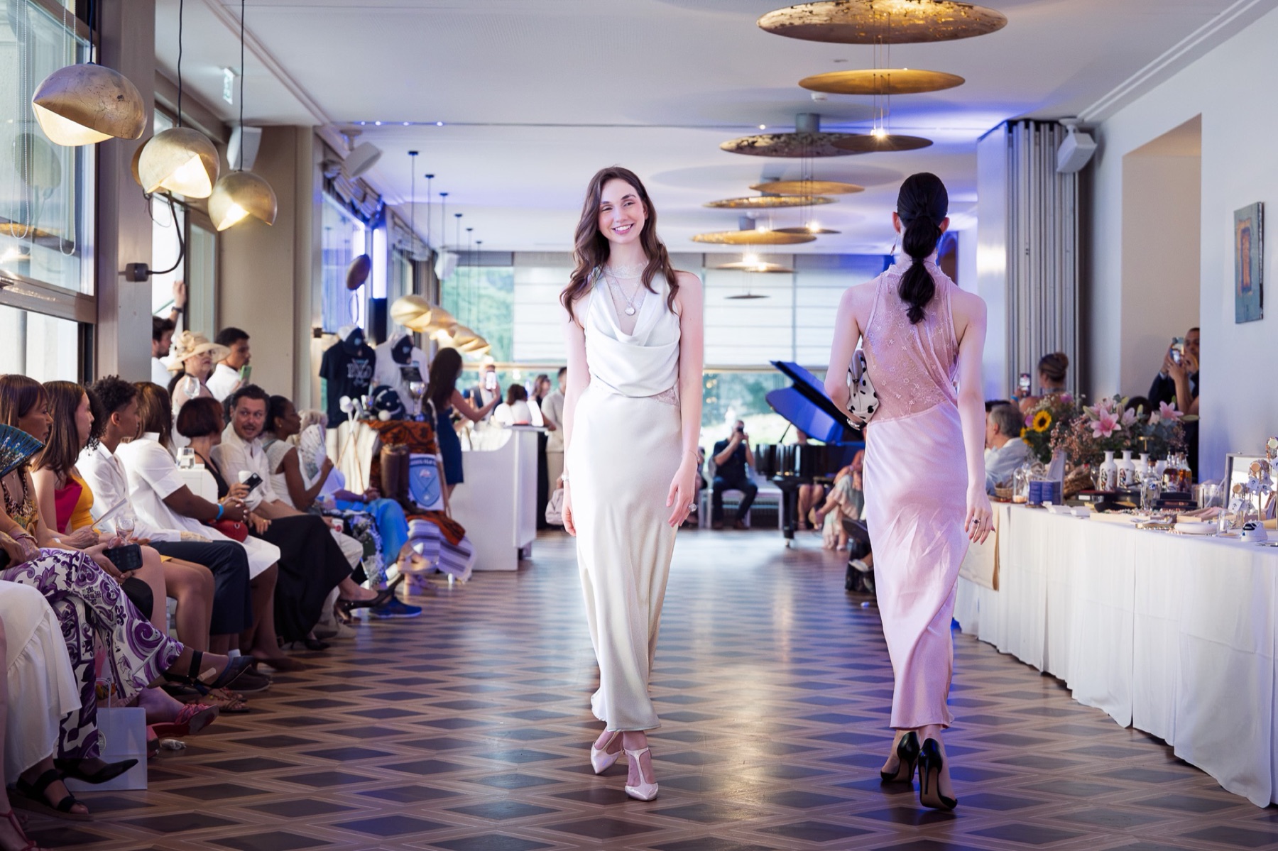 Two models crossing the Fashion Night runway