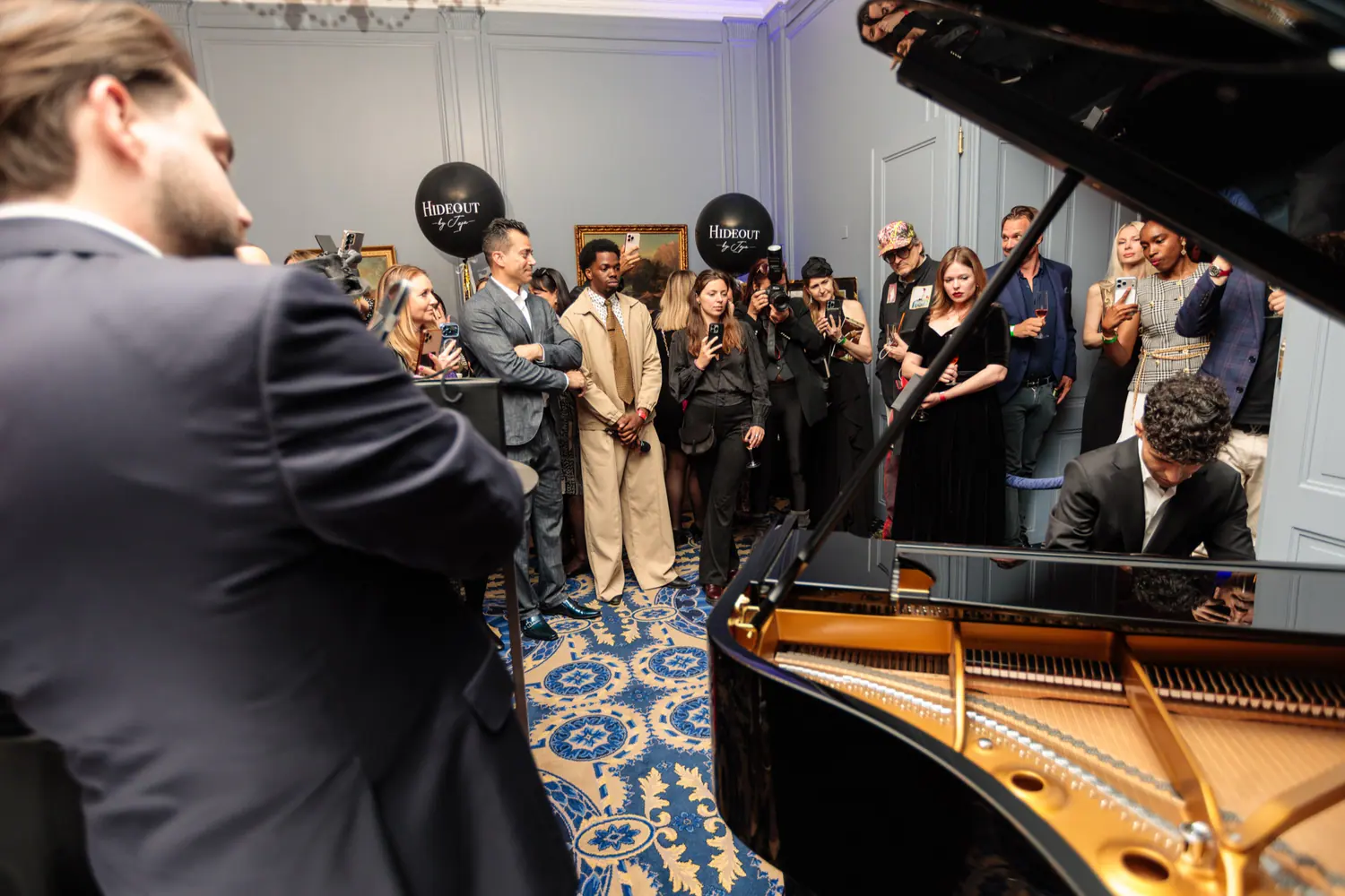 Guests gathered around a live pianist