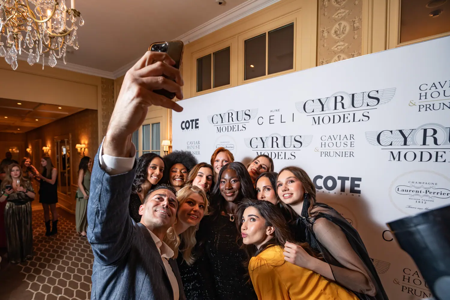 Models and guests taking a photograph after the show